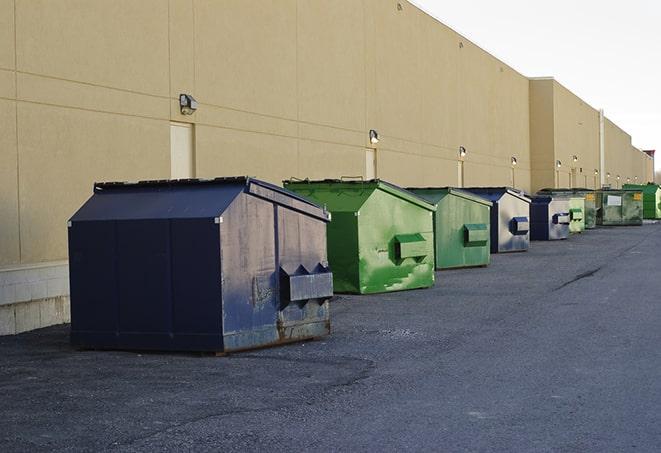 construction dumpsters stacked in a row on a job site in Alorton, IL